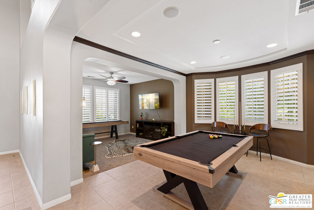 80592 Apricot Lane Indio, CA 92201 - Photo 15 of 45 a room with a table chairs and ceiling fan