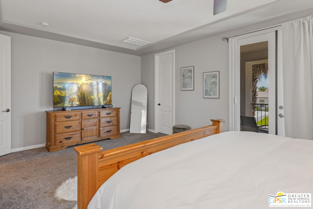80592 Apricot Lane Indio, CA 92201 - Photo 24 of 45 a bedroom with a bed and a flat screen tv