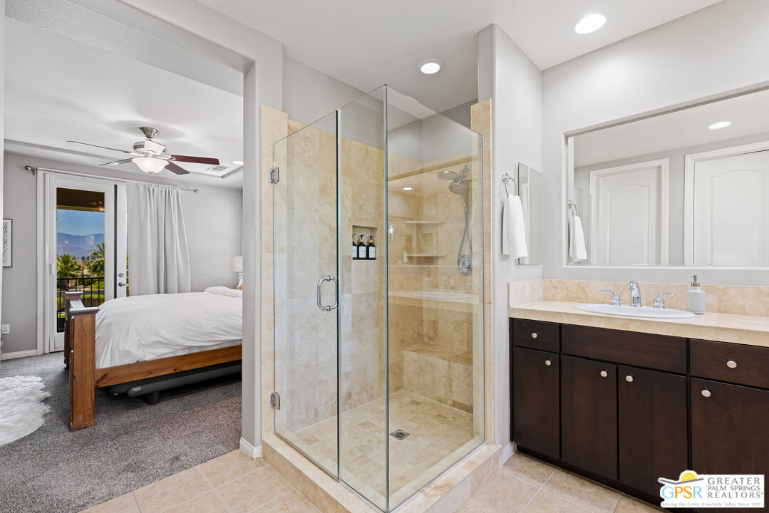 80592 Apricot Lane Indio, CA 92201 - Photo 27 of 45 a en suite bathroom with a shower sink and mirror
