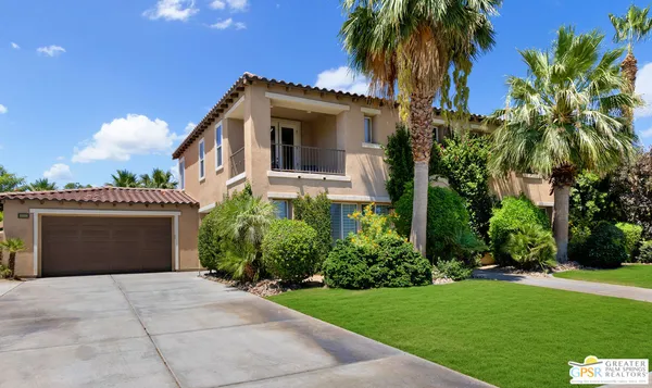 a front view of house with a garden