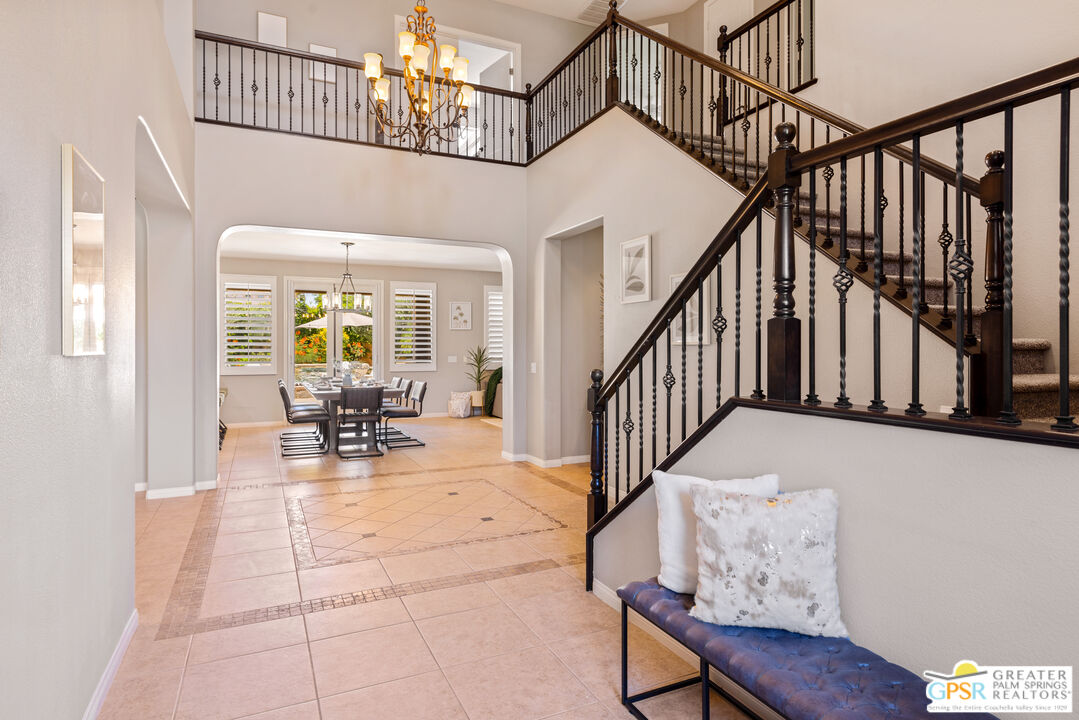 80592 Apricot Lane Indio, CA 92201 - Photo 5 of 45 a view of staircase with furniture and a chandelier
