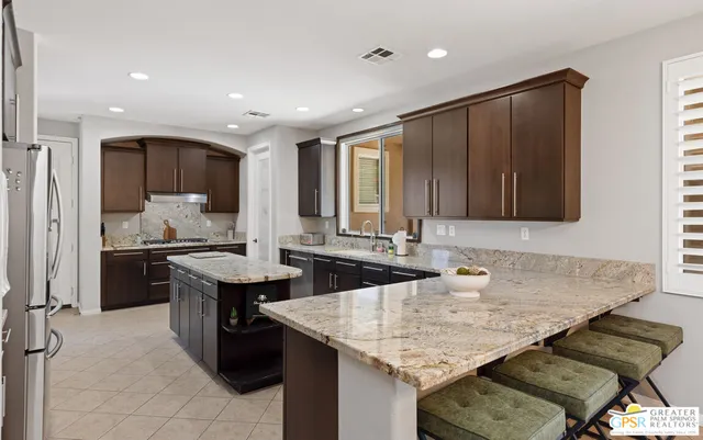 a kitchen with granite countertop a sink and a stove