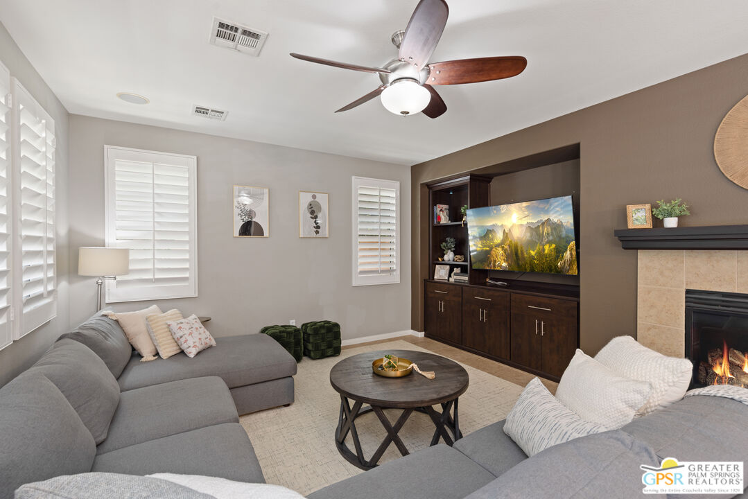 80592 Apricot Lane Indio, CA 92201 - Photo 9 of 45 a living room with furniture a flat screen tv and a window