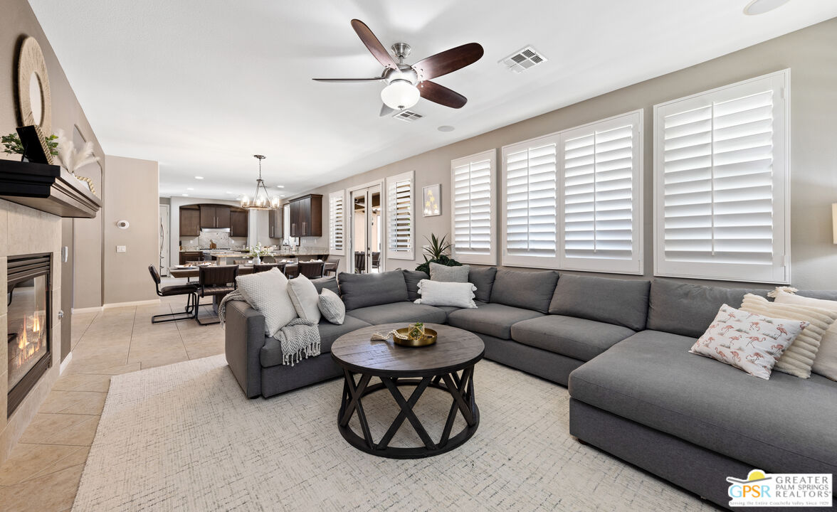 80592 Apricot Lane Indio, CA 92201 - Photo 10 of 45 a living room with furniture a fireplace and a large window