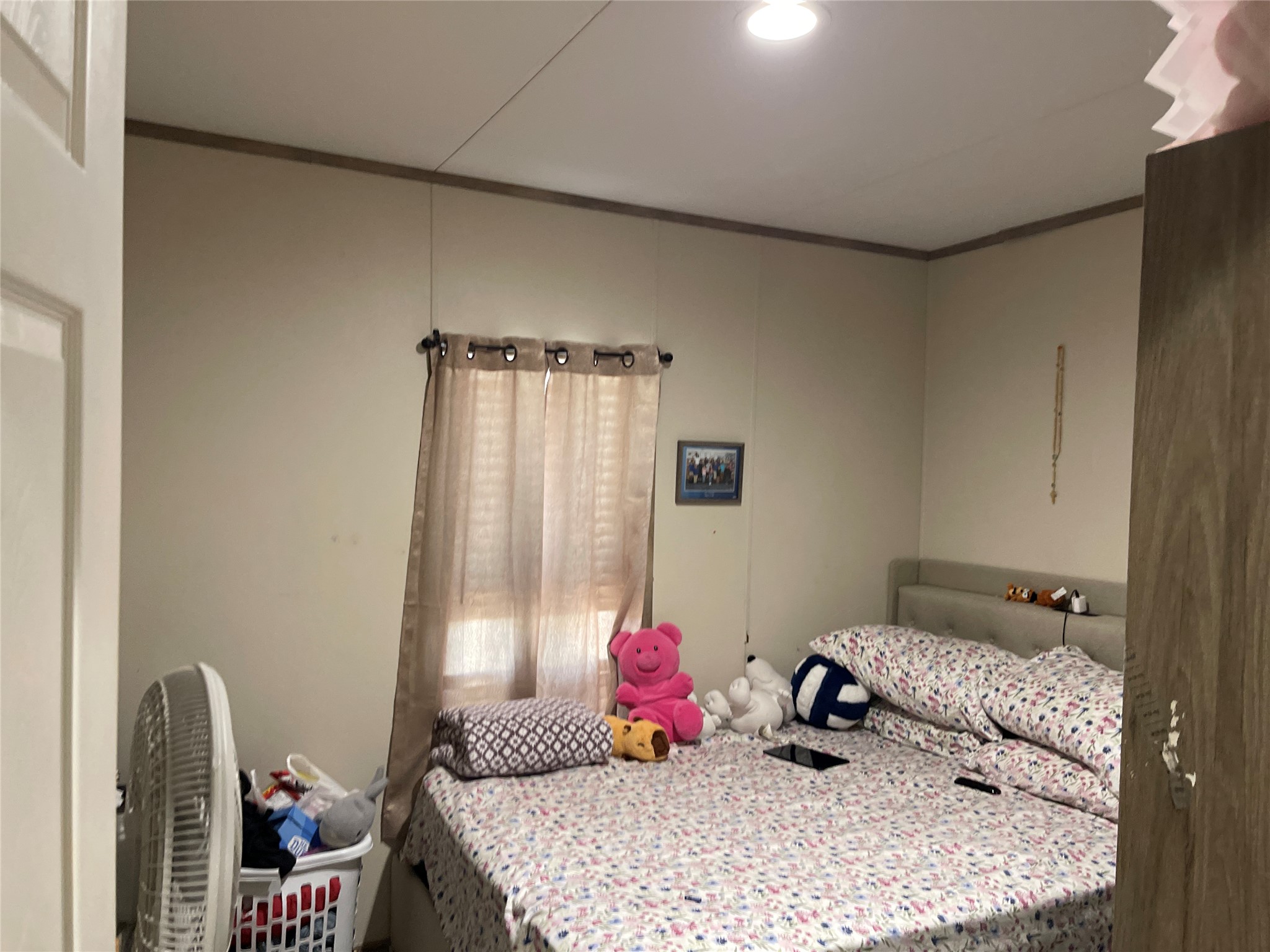 103 Azalea Avenue Elgin, TX 78621 - Photo 11 of 23 Recessed lighting illuminates this cozy bedroom complete with neutral walls and wood-trimmed ceilings.
