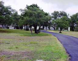 8709 South View Road Austin, TX 78737 - Photo 1 of 1 a view of a park with swings and slides