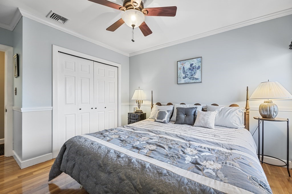 5 Colgate Road Marblehead, MA 01945 - Photo 23 of 36 a bedroom with a bed and wooden floor