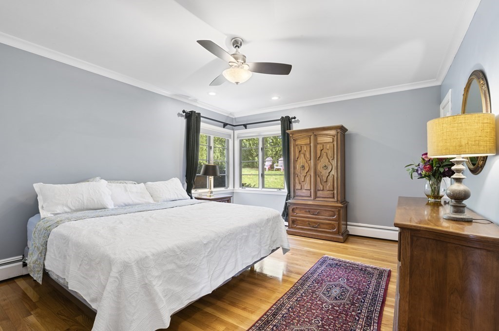 5 Colgate Road Marblehead, MA 01945 - Photo 25 of 36 a bedroom with a large bed and a chandelier