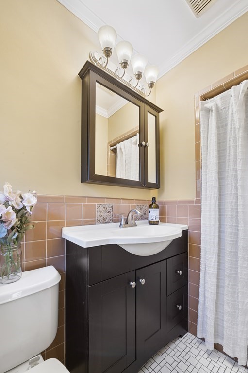 5 Colgate Road Marblehead, MA 01945 - Photo 27 of 36 a bathroom with a toilet sink and mirror