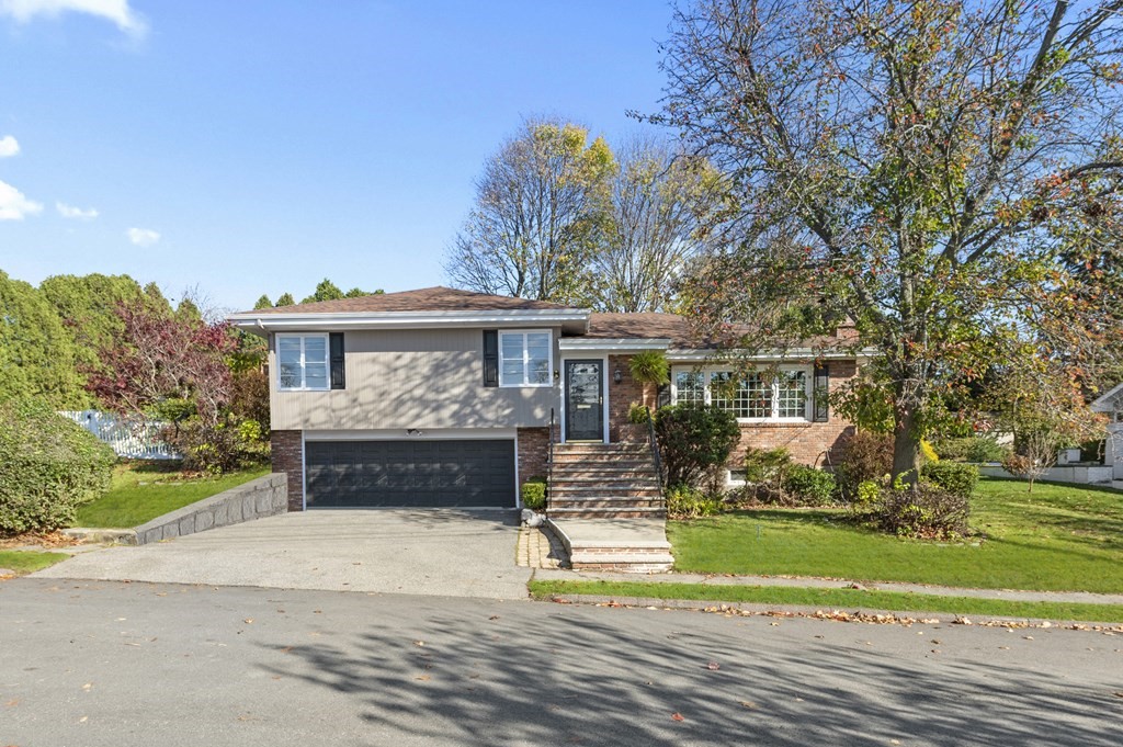 5 Colgate Road Marblehead, MA 01945 - Photo 3 of 36 a front view of a house with a yard and a garden