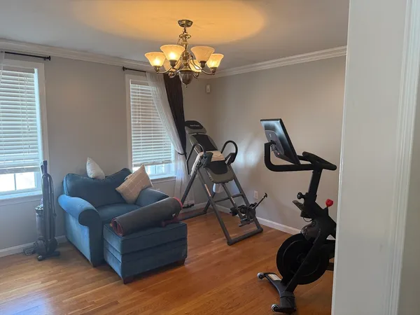 a living room with furniture a chandelier and a window