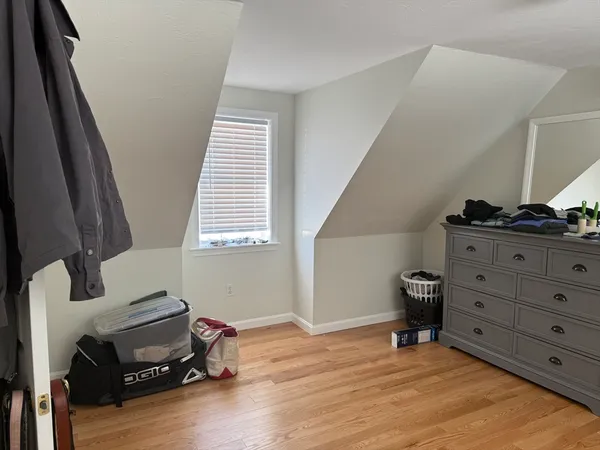 a bathroom with a granite countertop toilet sink and mirror