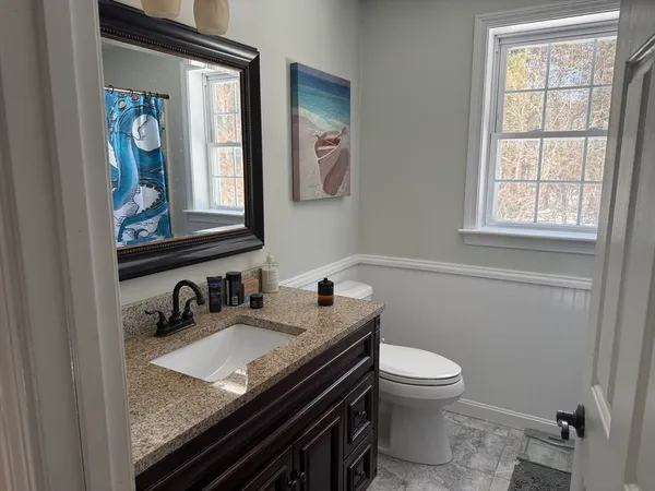 a bathroom with a large window and a shower