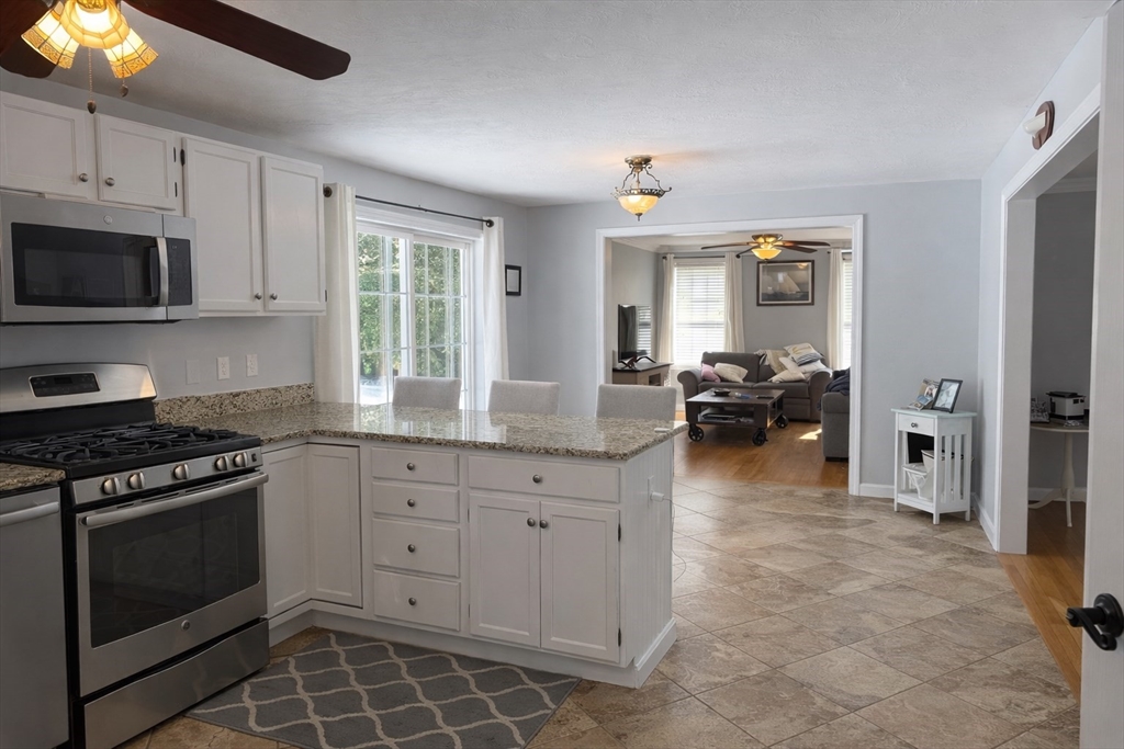 11 Trout Farm Way Wareham, MA 02576 - Photo 8 of 24 a kitchen with granite countertop a stove a sink and a refrigerator