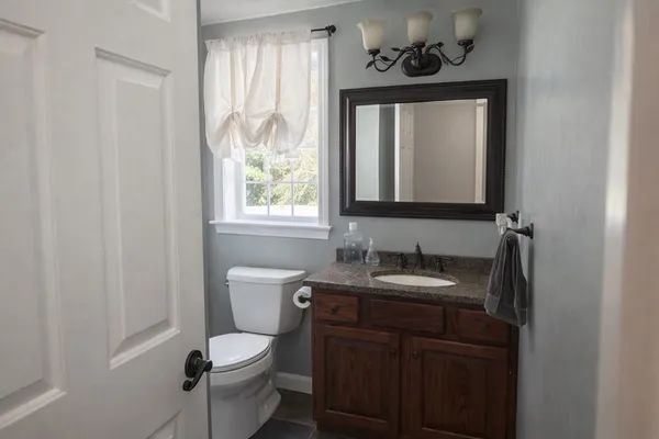 a bathroom with a toilet and a window