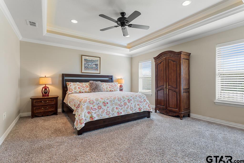 706 Duke Place Tyler, TX 75704 - Photo 12 of 33 a bedroom with a bed and a ceiling fan