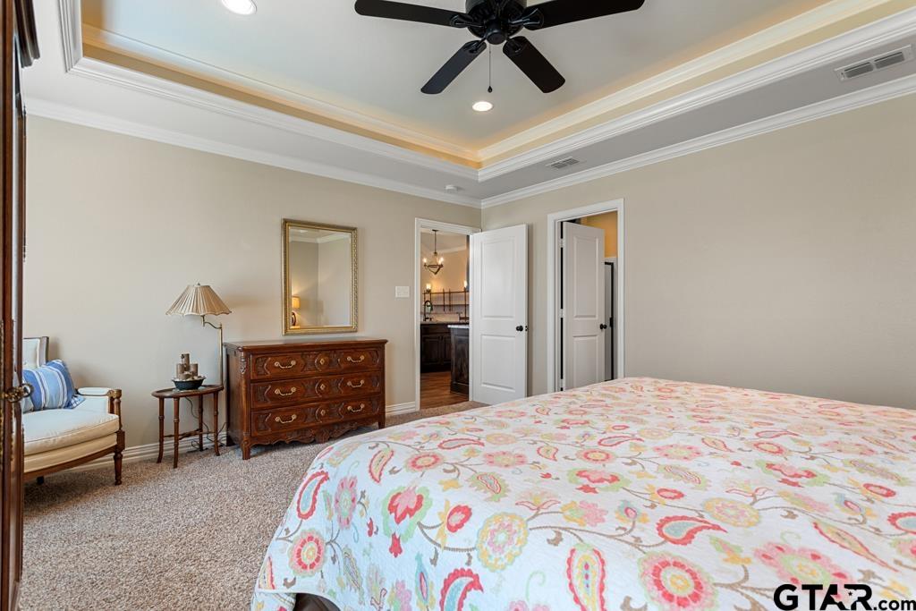 706 Duke Place Tyler, TX 75704 - Photo 13 of 33 a bedroom with a bed and a dresser