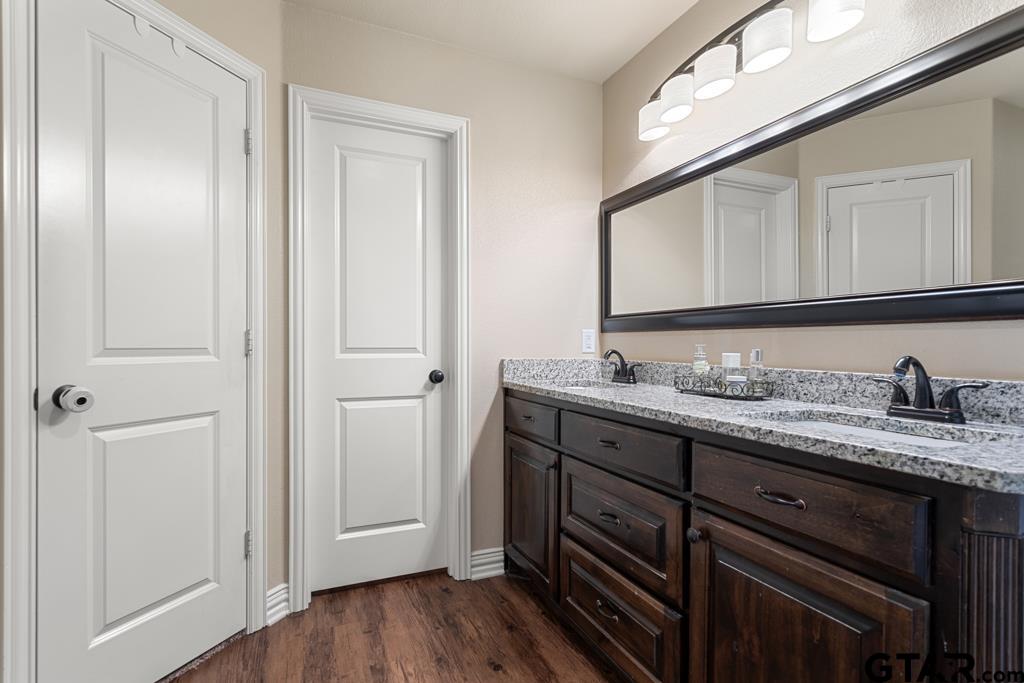 706 Duke Place Tyler, TX 75704 - Photo 16 of 33 a bathroom with a granite countertop sink and a mirror