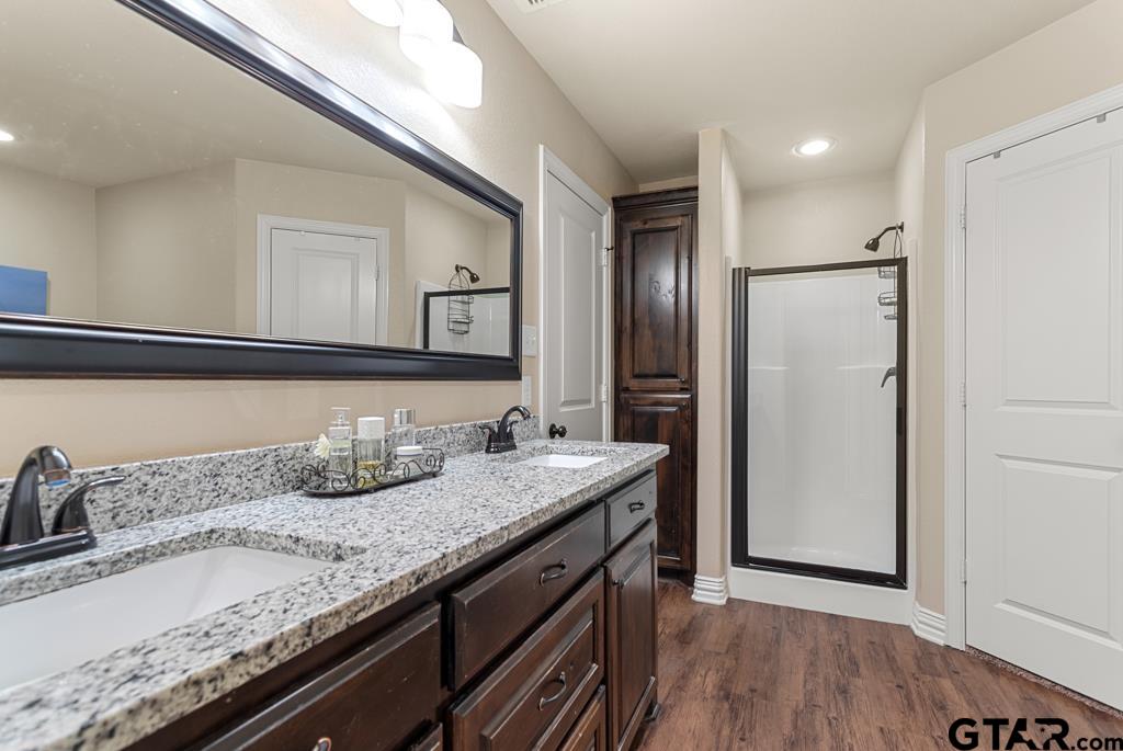 706 Duke Place Tyler, TX 75704 - Photo 17 of 33 a bathroom with a granite countertop sink and a mirror