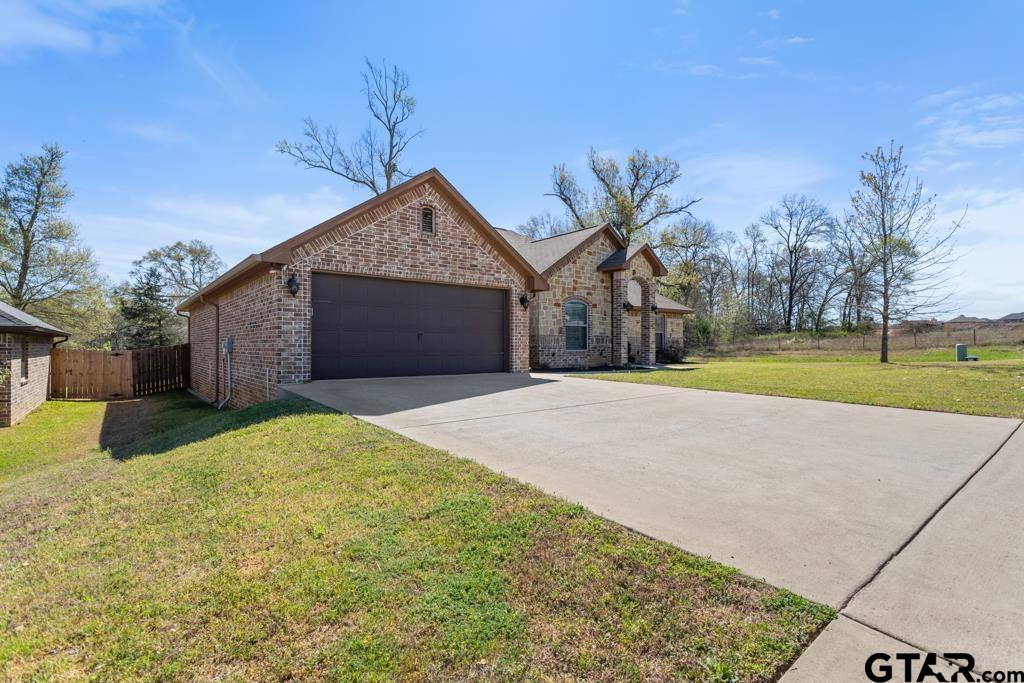 706 Duke Place Tyler, TX 75704 - Photo 2 of 33 a front view of a house with a yard and garage
