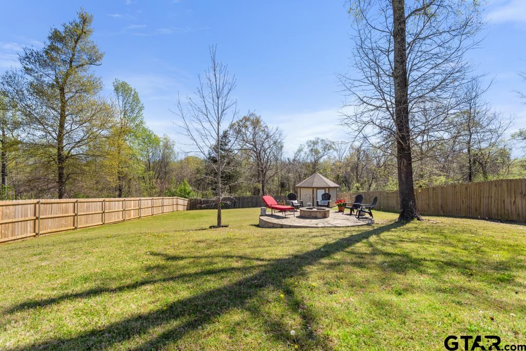 706 Duke Place Tyler, TX 75704 - Photo 27 of 33 a view of a swimming pool with a yard and trees