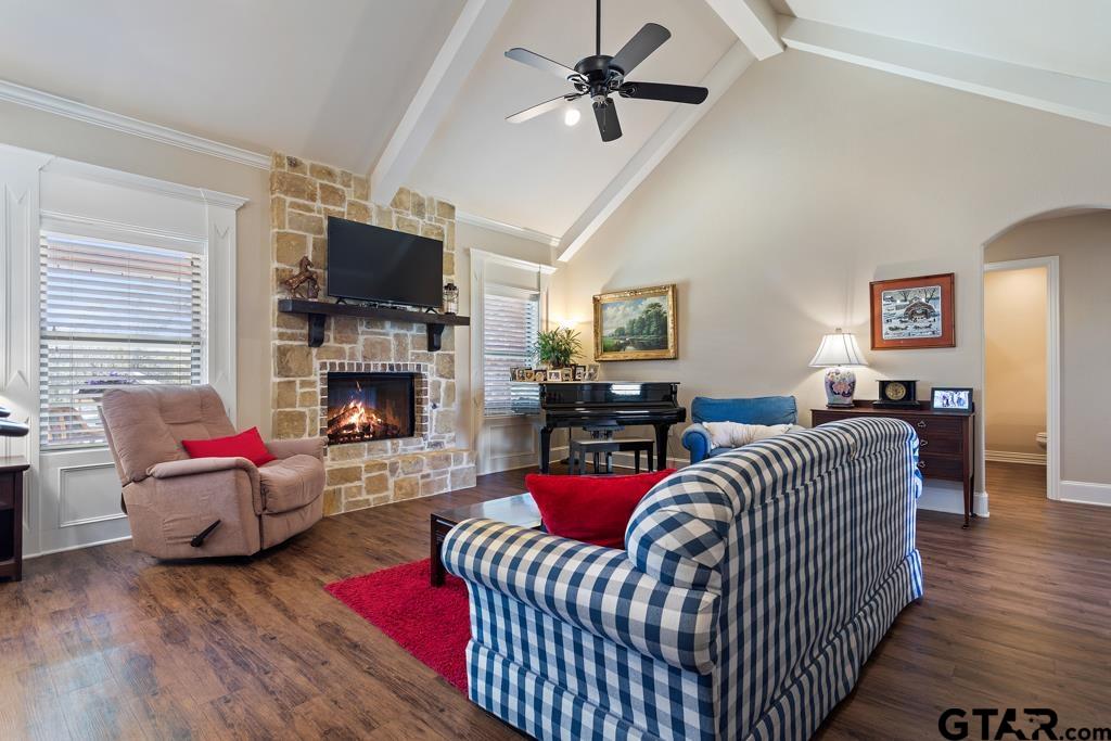 706 Duke Place Tyler, TX 75704 - Photo 7 of 33 a living room with furniture a flat screen tv and a fireplace