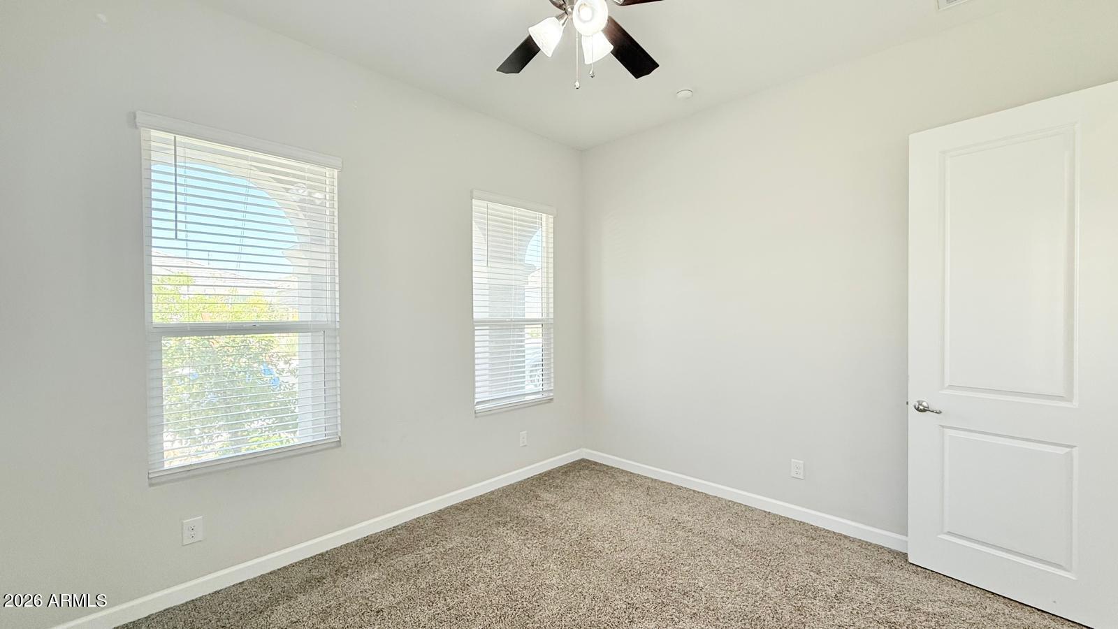 2141 East Alameda Road Phoenix, AZ 85024 - Photo 6 of 15 an empty room with a window and a fan