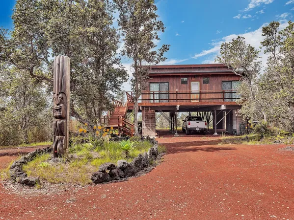 a front view of a house with a yard table and chairs