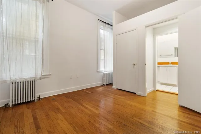 a view of an empty room and wooden floor