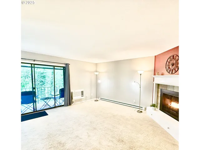 a view of an empty room with a fireplace