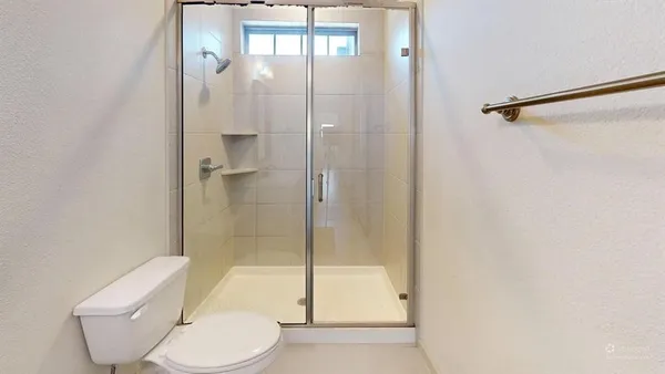 a bathroom with a toilet and shower