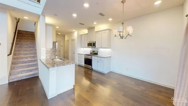a kitchen with kitchen island a sink stainless steel appliances and cabinets