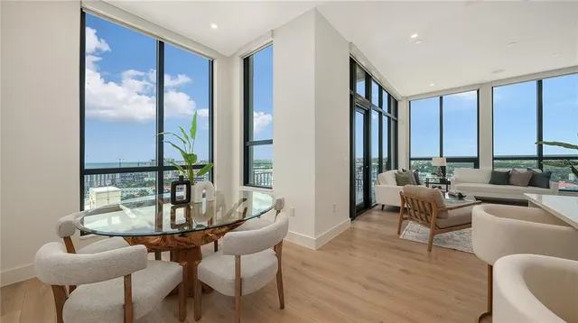 a dining room with furniture and wooden floor