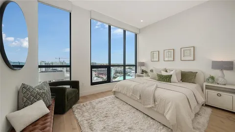 a bedroom with a large bed and a large window