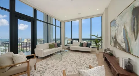 a living room with furniture and large windows