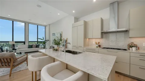 a kitchen with stainless steel appliances granite countertop a sink and cabinets