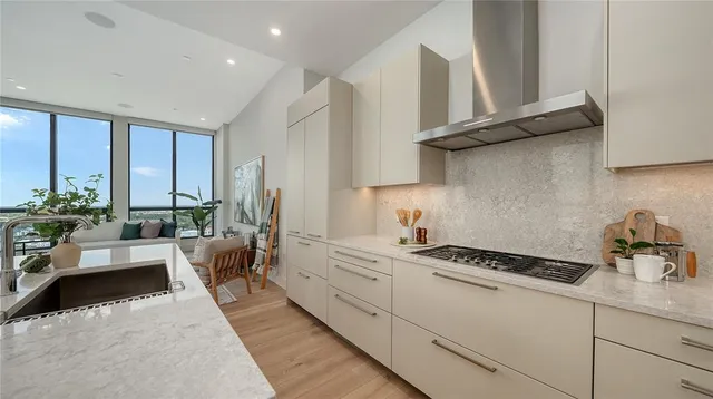 a kitchen with stainless steel appliances a sink a stove and cabinets