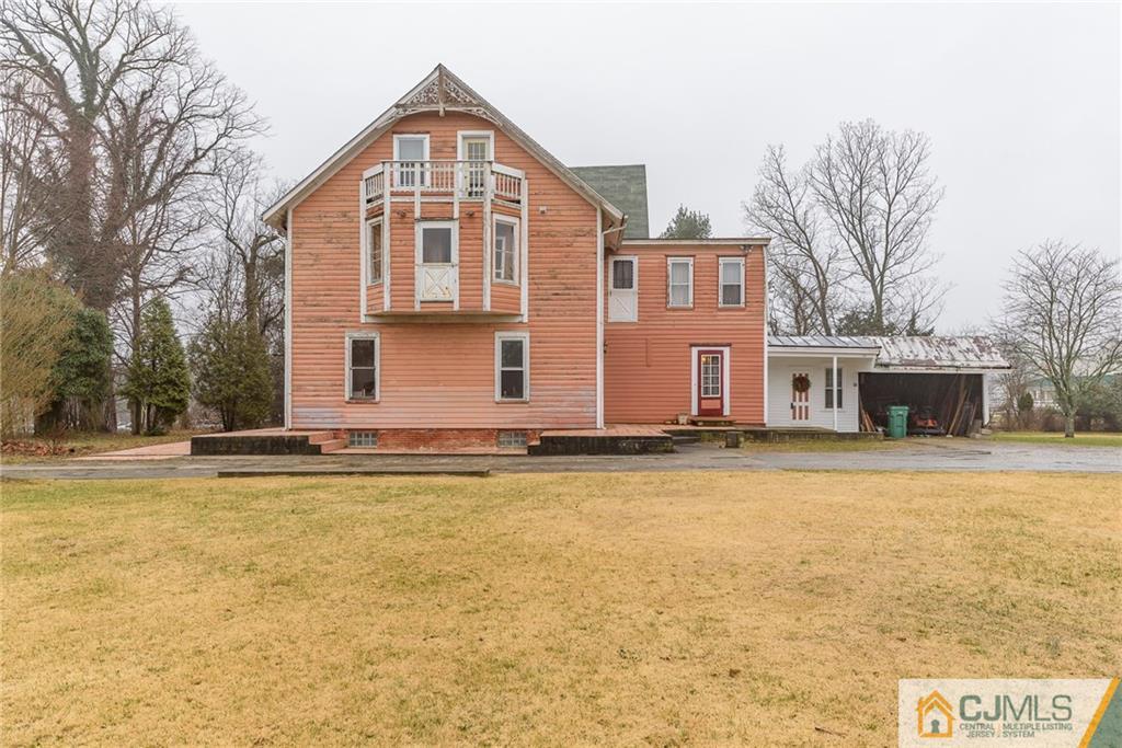 176 Burlington Path Road Cream Ridge, NJ 08514 - Photo 22 of 23 a front view of house with yard and trees in the background
