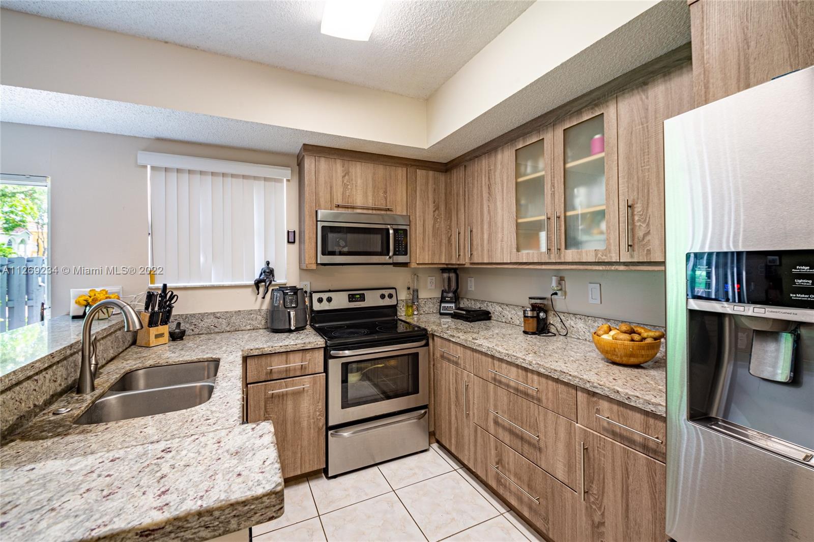 Doral Doral, FL 33178 - Photo 12 of 25 a kitchen with a sink stove and microwave