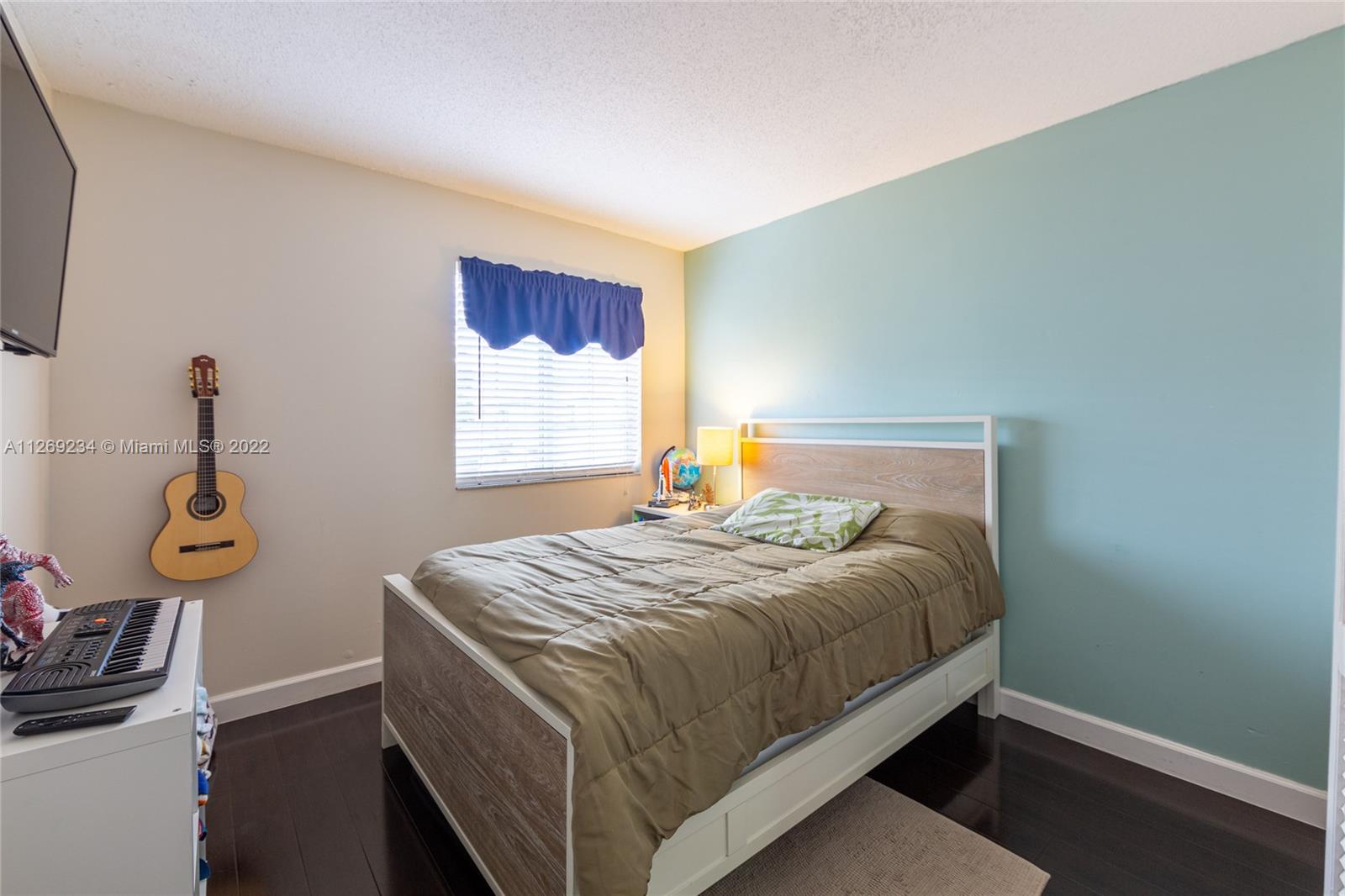 Doral Doral, FL 33178 - Photo 20 of 25 a bed sitting in a bedroom next to a window