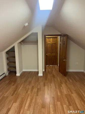 an empty room with wooden floor and closet