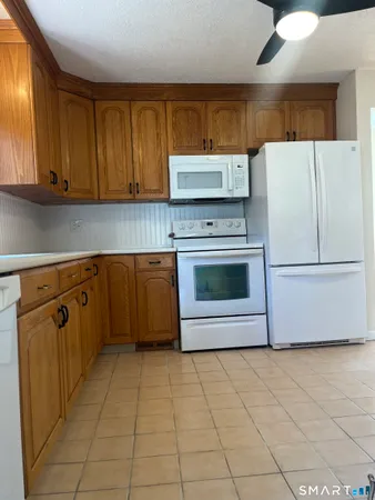 a kitchen with stainless steel appliances a stove a refrigerator sink and cabinets