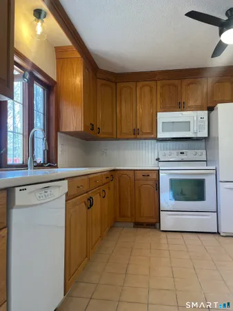 a kitchen with cabinets appliances and a counter top space