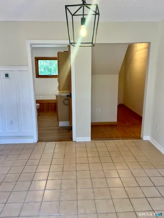 a view of a livingroom with wooden floor and cabinet