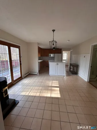 a view of empty room with a fireplace and windows