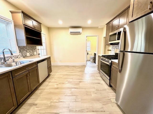 37 Gordon Street, Unit 1 Waltham, MA 02453 - Photo 1 of 12 a large kitchen with stainless steel appliances a refrigerator and a sink