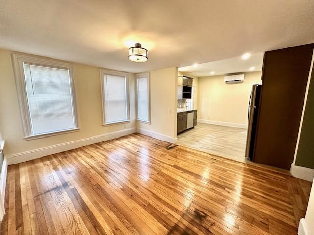 37 Gordon Street, Unit 1 Waltham, MA 02453 - Photo 12 of 12 a view of empty room with wooden floor and fan