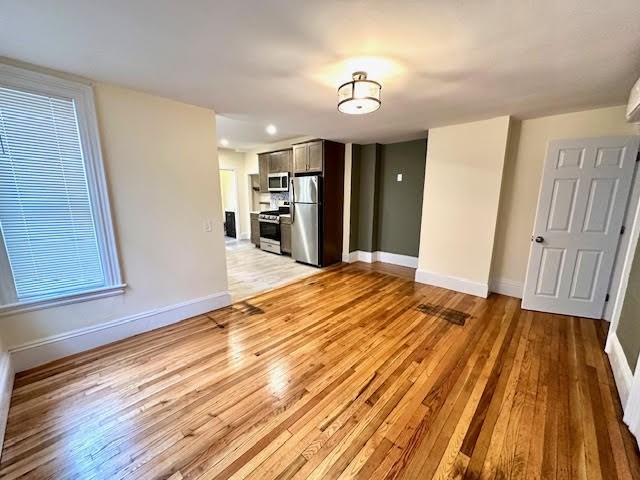 37 Gordon Street, Unit 1 Waltham, MA 02453 - Photo 8 of 12 a view of a room with wooden floor and staircase
