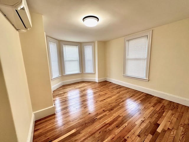 37 Gordon Street, Unit 1 Waltham, MA 02453 - Photo 9 of 12 a view of an empty room with wooden floor and a window