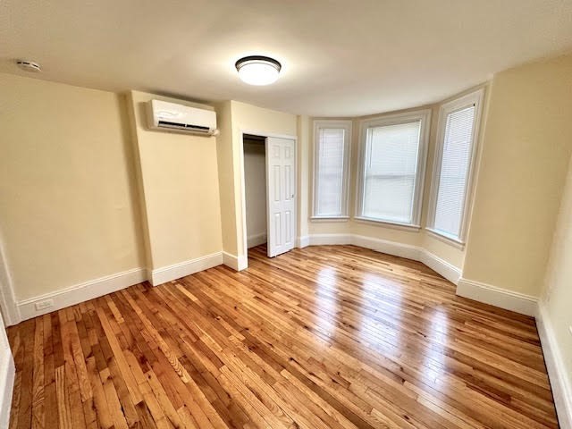 37 Gordon Street, Unit 1 Waltham, MA 02453 - Photo 10 of 12 an empty room with wooden floor and windows